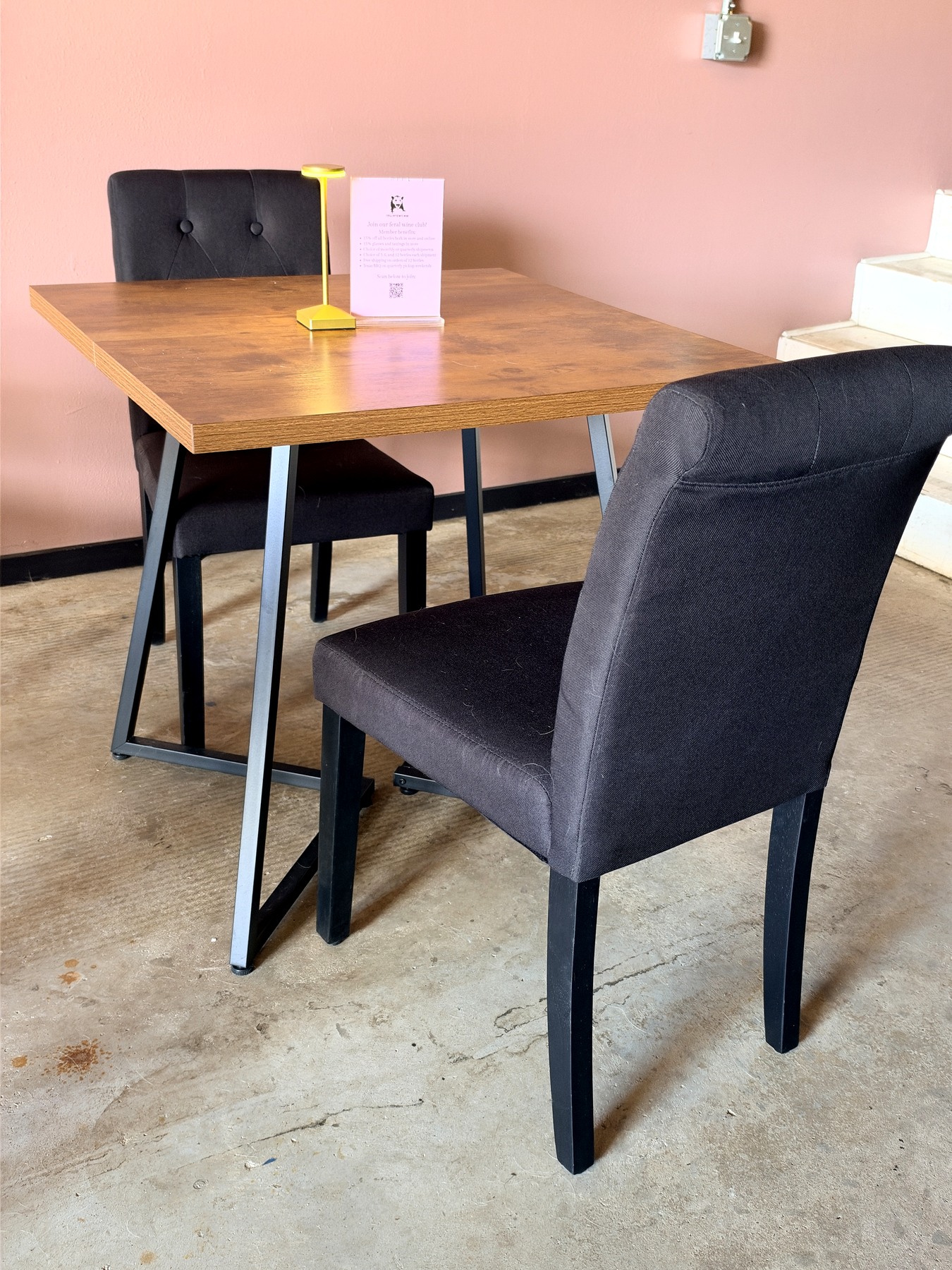 A cozy table inside the Feral Housewife Wine tasting room